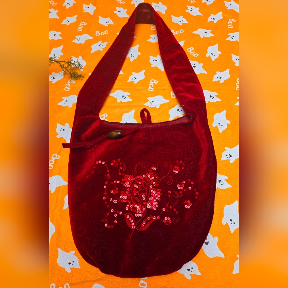 Velour sequined hobo bag. Burgundy with thick strap. Snaps on top.